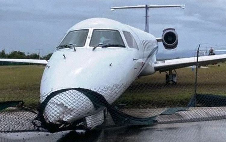 The aircraft entangled in the perimeter fence
